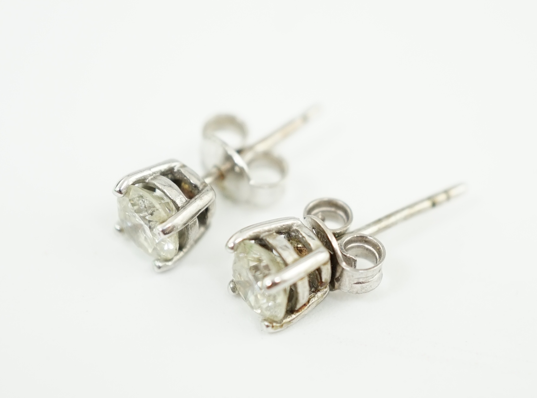 A pair of 18k white gold and solitaire diamond set ear studs